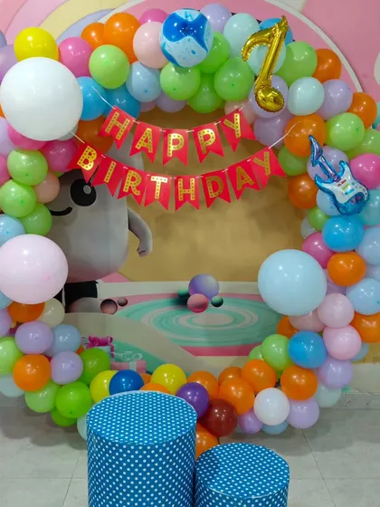 A colorful circular balloon arch with a music theme. The decoration includes guitar foil balloons and a music note, perfect for a little rockstar.