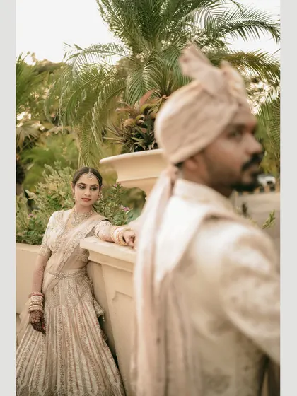 A creative portrait with the groom out of focus in the foreground, drawing all attention to the bride's gaze.