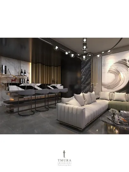 The bar and lounge area of the M3M penthouse, designed for hosting. The geometric marble bar front, modern bar stools, and dramatic wall art come together to create a space with the ambiance of an exclusive private club.
