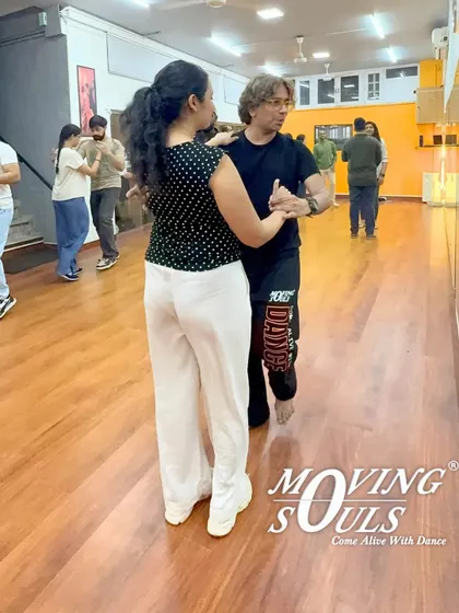 Our instructor guiding a student through a basic Salsa pattern. We provide individual attention to help you understand the nuances of the dance.