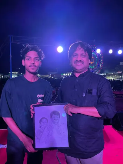 Presenting a framed portrait to a respected dignitary on stage during a public event. It is an honor to have my art be part of such important occasions.