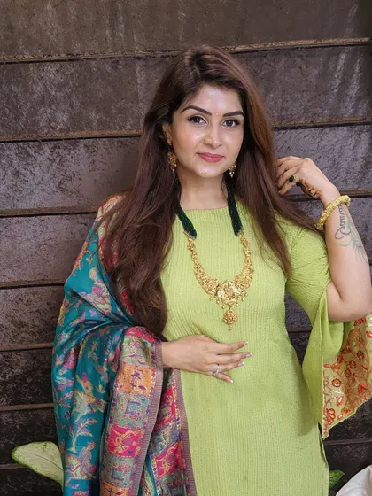 A beautiful lime green kurta with bell sleeves, paired with a vibrant, multi-colored Banarasi dupatta. This look celebrates Indian handloom in a fresh, modern way.
