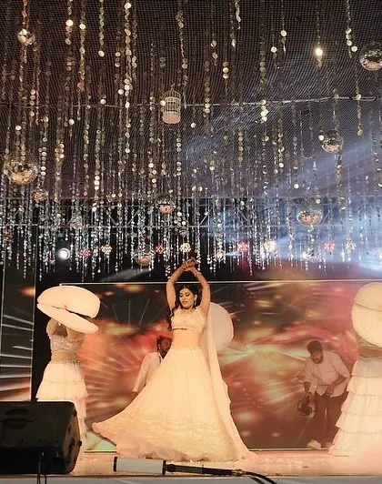 A wide shot of a bridal solo, showing how we use the entire stage, props like umbrellas, and smoke effects to create a grand, theatrical performance.