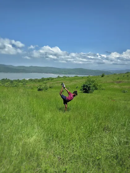 Practicing Natarajasana (Dancer's Pose) in a field in Gokarna. For me, setting a stage for practice is like worshipping the body, finding beauty in the movement and the surroundings.