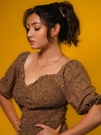 A modern portrait with a yellow background. The simple styling and confident pose create a fresh and contemporary look.