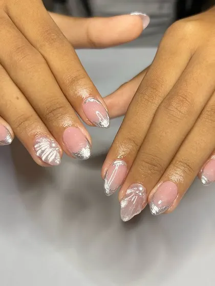 An ethereal and delicate set with a silver chrome French tip and hand-painted, translucent white flowers.