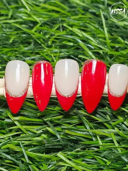 A modern take on the French manicure. This set features a classic red tip with a fine line of silver glitter for a festive and elegant touch.