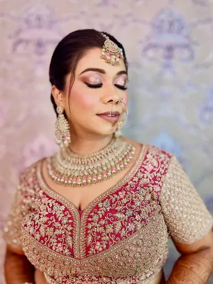A soft and dreamy close-up. The shimmering eyeshadow and gentle pink tones create a romantic and ethereal bridal look.