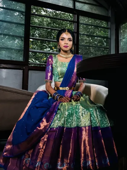 A regal portrait in a traditional half-saree. This is a classic look for many South Indian pre-wedding ceremonies.
