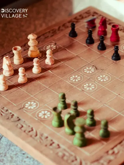 A beautifully carved wooden chessboard is set for a game. We offer a variety of traditional board games for quiet, strategic afternoons.