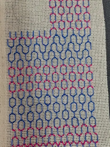 A phone insert being made with a two-tone geometric pattern. The video shows the different stages, from the first few stitches to the nearly completed piece.