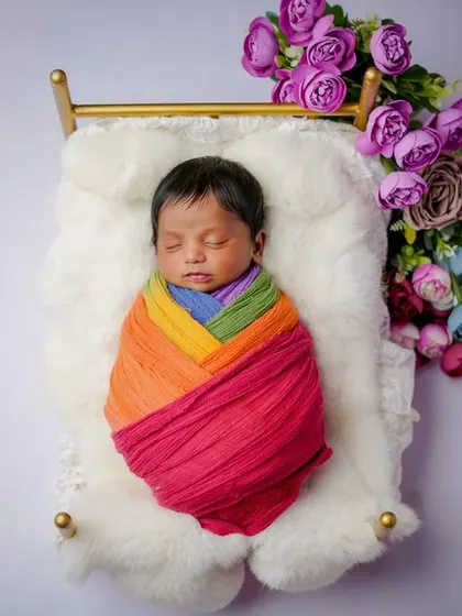 Wrapped in a rainbow. I love using multi-colored wraps to create a vibrant and joyful portrait that celebrates your precious gift.