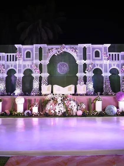 This reception stage was designed to be the romantic centerpiece of the evening. Featuring intricate white architectural details, soft floral accents, and elegant uplighting, it provided a beautiful backdrop for the couple throughout the celebration.