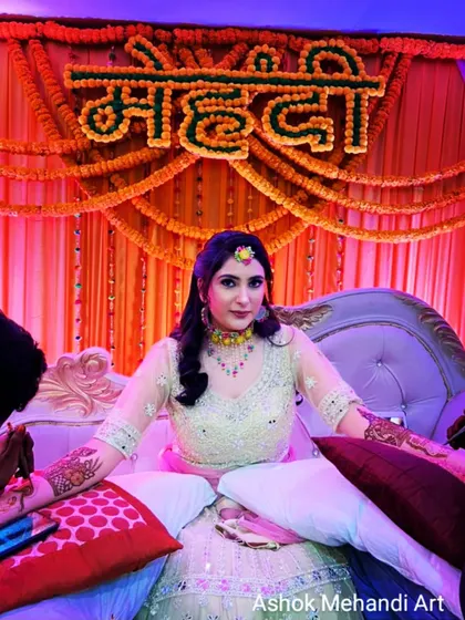A behind-the-scenes look at a mehndi ceremony. I always ensure my brides are comfortable, using pillows for support during the long hours of application.