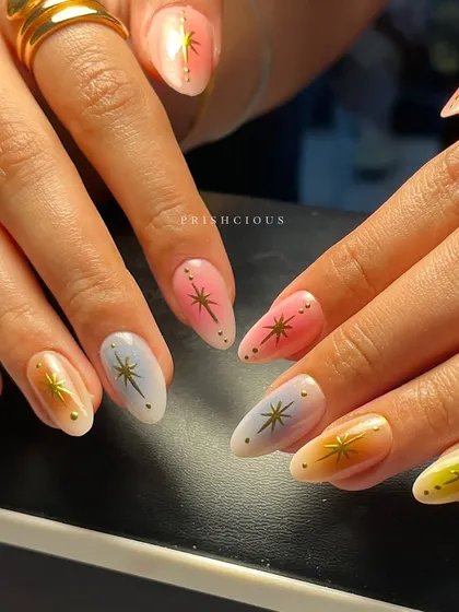 Aura nails are such a vibe, and this set is a total fav. I created a soft, multi-color gradient on each nail using dreamy pastels like pink, yellow, and blue, then topped them with delicate gold starbursts for that extra sparkle.
