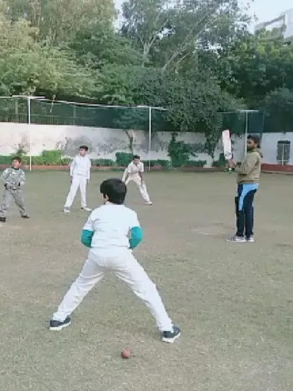 Young trainees engage in a fielding drill, learning proper positioning and anticipation. Teamwork and communication are emphasized in every session.