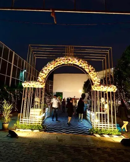 For the 60th birthday, we extended the black and white chevron theme to the outdoor seating and entrance arch. Themed furniture and chandelier centerpieces created a cohesive and elegant experience.