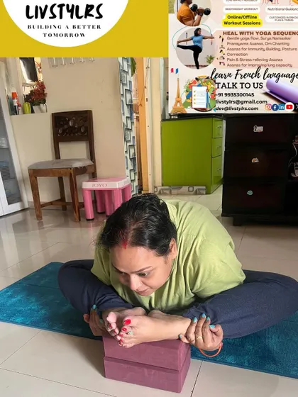 A client practices Baddha Konasana (Bound Angle Pose) using yoga blocks for support. This modification allows for a deeper hip opening while maintaining comfort and proper alignment.