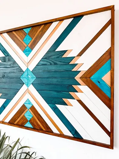 An angled shot that captures the scale and vibrant presence of the large Aztec-style wall hanging.