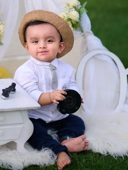 This little boss baby is ready for his close-up. For themed shoots, I use props like this miniature desk and a cozy fur rug to create a complete and adorable scene for your child's portrait session.