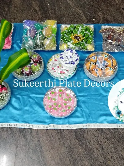 For this ear piercing ceremony in Coimbatore, I created a set of platters with a vibrant blue theme. The arrangement includes decorated sweets, dry fruits, and a floral centerpiece, all wrapped and ready for the function.