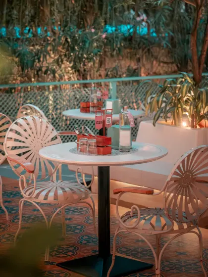 The patio at twilight, where the intricate ironwork chairs and soft lighting create an enchanting atmosphere for an evening of conversation and cocktails under the stars.