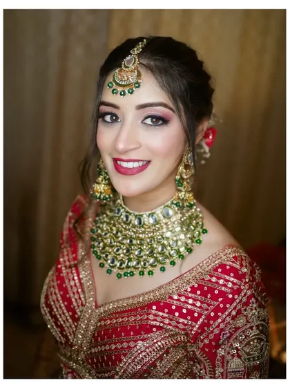 The radiance of a Punjabi bride is unmatched. I focus on creating portraits that highlight not just the stunning red lehenga and royal kundan jewelry, but also the bride's personality and joyful anticipation. This is a classic bridal portrait that celebrates heritage and elegance.