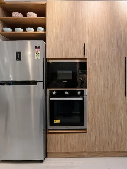 A detail of the tall unit in the kitchen, which houses the refrigerator and built-in appliances, providing seamless and efficient storage.