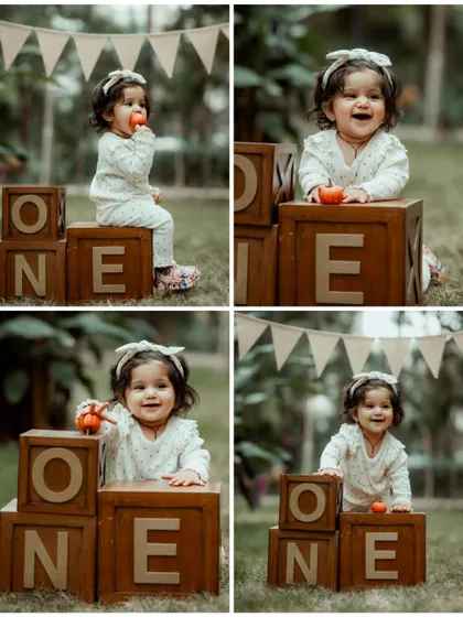 A four-photo collage celebrating a first birthday, showing a baby girl in a white outfit playing with "ONE" blocks and a pumpkin prop.