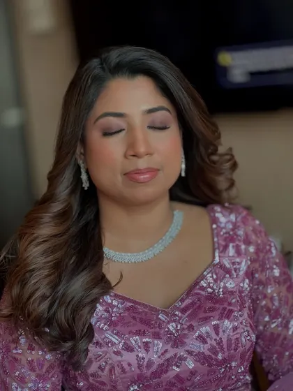 Eyes closed, you can see the beautiful blend of purple and silver eyeshadows we used for her reception look. It’s all in the details.