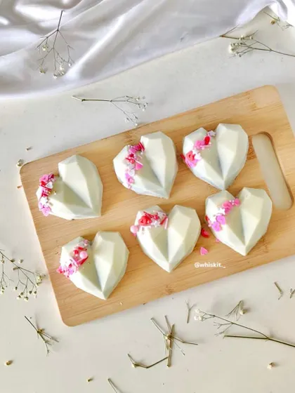 Geometric heartsicles decorated with pink and red sprinkles. These are a modern and stylish alternative to traditional cake pops.