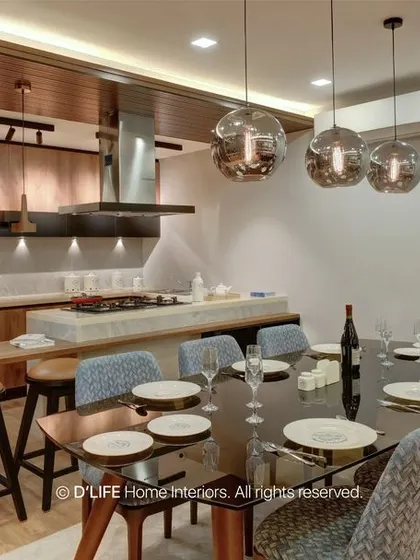 The open-plan dining and kitchen area is perfect for entertaining. The large dining table is complemented by the functional and stylish kitchen island in the background.