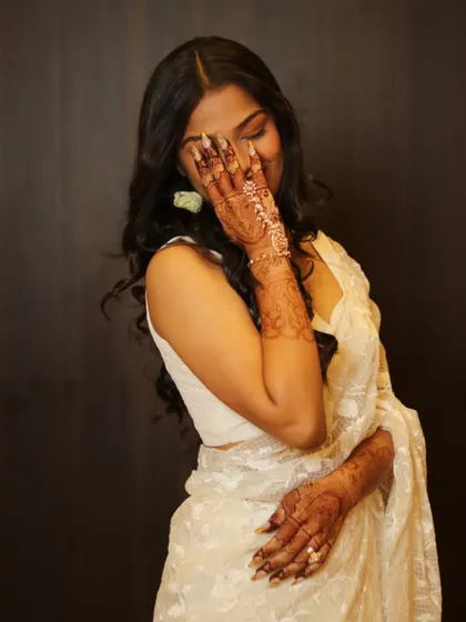 A candid, happy moment. The rich stain of her mehendi is visible as she shares a laugh, showing how henna is part of the joy of a wedding.