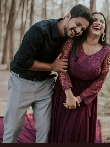 Laughter and love in the woods. This candid shot shows a happy couple enjoying their pre-wedding shoot in their comfortable yet stylish coordinated outfits.