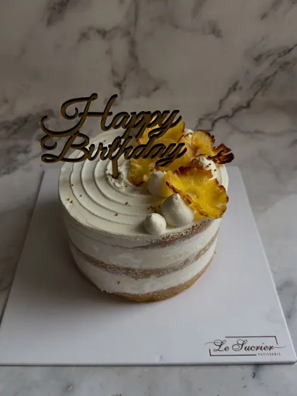 My Fresh Pineapple Cream Cake is a tropical delight, featuring a light sponge and cream filling, topped with caramelized pineapple slices.