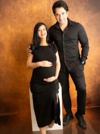 A classic full-length couple's portrait. Coordinating in black outfits creates a sleek, sophisticated, and timeless look.