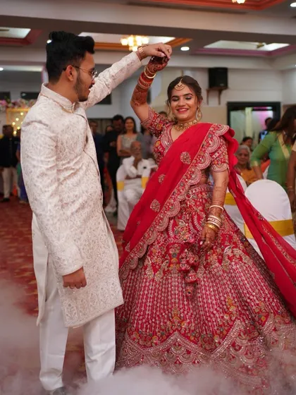 A magical first dance. The bride's classic red bridal glam, with its flawless finish, ensures she looks stunning as she twirls.
