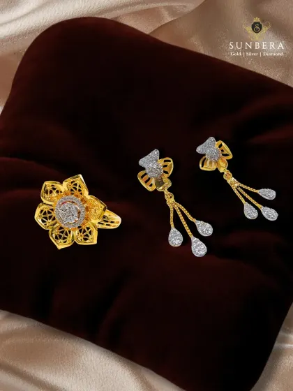 This gold jewellery set, featuring a floral ring and matching drop earrings, combines traditional filigree work with the sparkle of diamonds. It’s a harmonious blend of heritage and modern glamour.