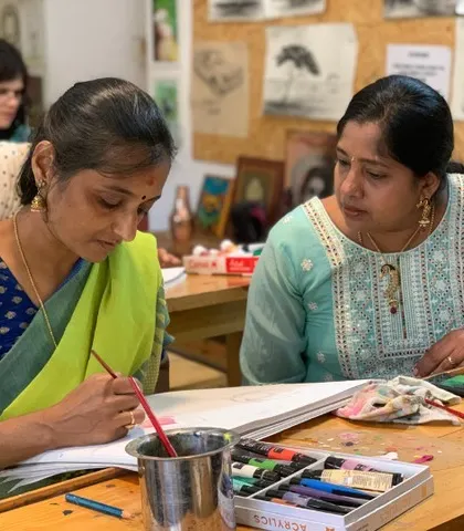 In our Gurukul, learning is a shared journey. Here, I am helping a student with her color palette. We keep our batches small to ensure everyone gets this kind of personal guidance, helping you build both skill and confidence.