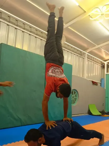 A collection of different partner handstand variations. These exercises range from handstands on a partner's back to one-arm assisted holds, all designed to build strength and teamwork.