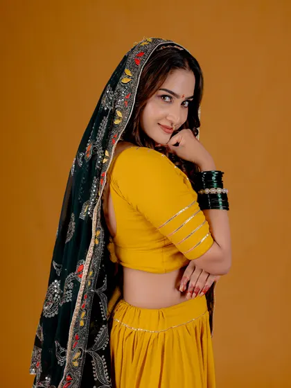 A playful and engaging pose from a studio session. This image shows how I direct models to bring energy and personality to traditional wear.