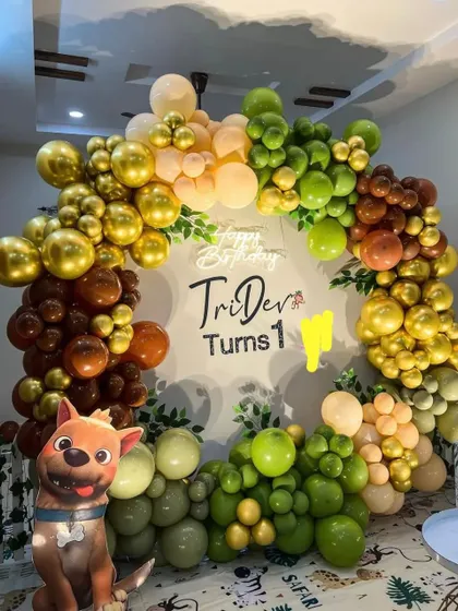 A Paw Patrol inspired first birthday party. This decoration features a circular balloon arch in earthy tones and a character cutout.