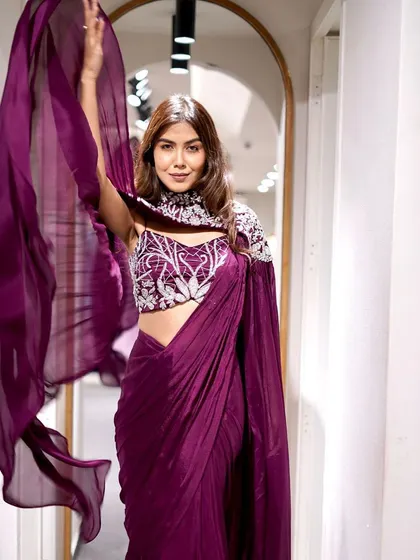 Saree up for the festivities! Add a touch of royalty to your look with this majestic dark purple pre-draped saree.