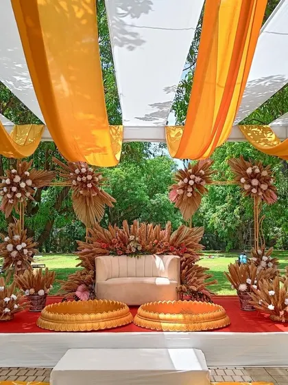 A straight-on shot of the elegant boho Haldi stage. This setup is perfect for couples looking for a contemporary twist on traditional Haldi decor.