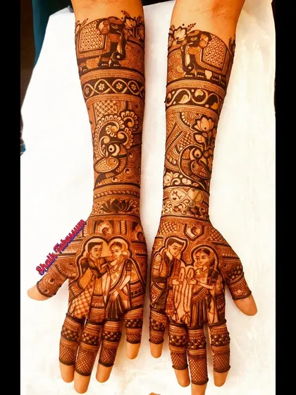 A heartwarming family portrait is the centerpiece of this bridal mehendi, complemented by traditional elephant and peacock motifs on the arms.