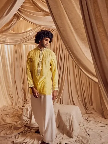 A wide shot from the Kunal Anil Tanna campaign. Even from a distance, the professional grooming ensures the model looks polished and put-together, fitting the elegant aesthetic of the collection.