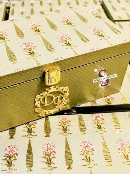 A close-up of the custom-designed monogram lock on the mint green invitation box. These small, personalized details are what make my wedding stationery truly special and unique to each couple.