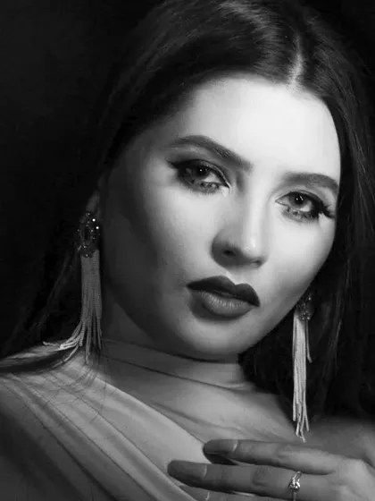 A softer, more glamorous pose within the same black and white shoot.