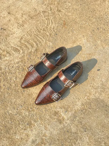My new bestseller, the buckled ballet flat in a rich, brown croc-embossed leather. The texture of the leather combined with the silver hardware creates a shoe that feels both luxurious and modern.