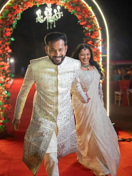 The couple's grand entrance through a floral arch, a moment perfectly timed and executed by our team.
